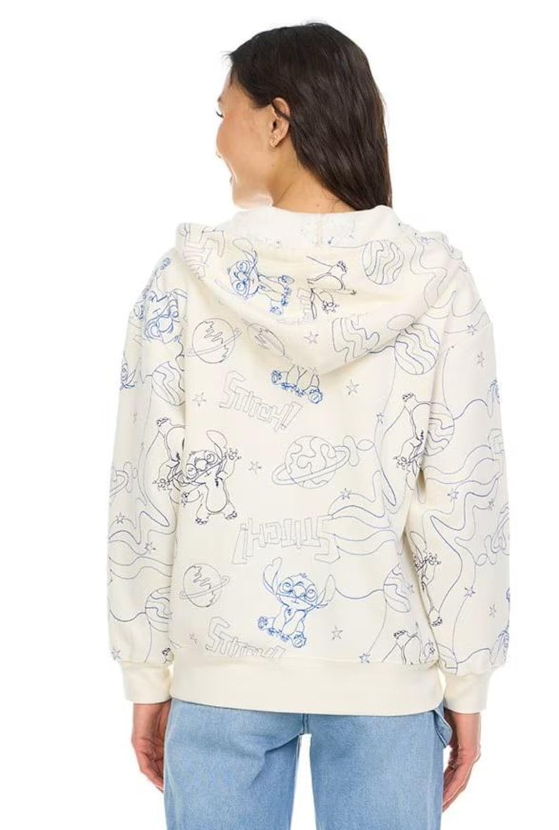 May include: Cream-colored hoodie featuring a blue line art design of Stitch, planets, and stars. The word "Stitch!" is repeated throughout the design. The hoodie has a drawstring hood and ribbed cuffs and hem.