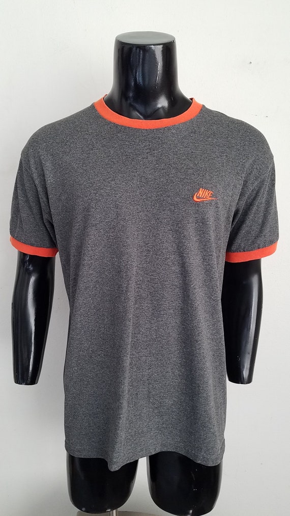 gray and orange nike shirt