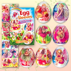 May include: Egg sleeves featuring "Flower Fairies" designs. The packaging shows images of fairies, butterflies, and ladybugs. Several decorated eggs with fairy illustrations are also displayed, showcasing the shrink-wrap film's application.