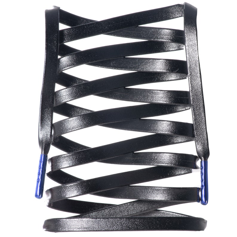 May include: Black leather shoelaces with blue aglets, arranged in a criss-cross pattern.