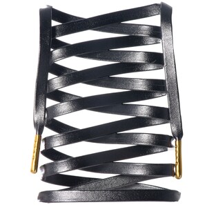 May include: Black leather shoelaces with gold metal tips, woven into a criss-cross pattern.