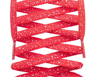 May include: Red shoelaces with white speckles. The laces are crisscrossed and tied together.