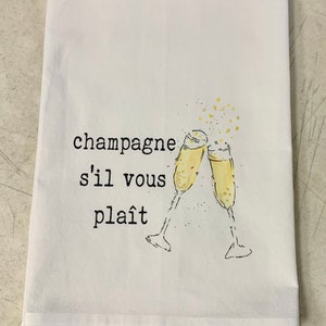 May include: White kitchen towel with the text "champagne s'il vous pla&icirc;t" and a drawing of two champagne glasses clinking.