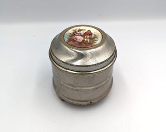 Antieke jaren 1930 ijdelheid poederdons opwind muziekdoos aluminium porselein pictograph