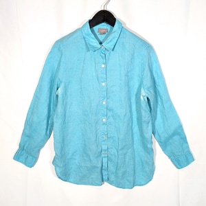 May include: A light blue long-sleeve button-down shirt. The shirt is made of a lightweight fabric and features a classic collar and buttoned cuffs. The shirt is hanging on a black hanger against a white background.
