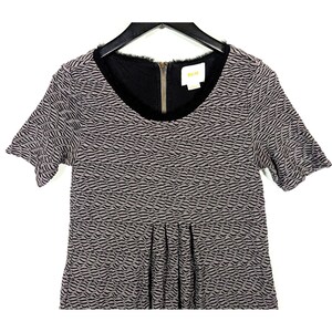 May include: A short-sleeved dress with a textured wave pattern in gray and black. The dress features a black neckline with a gold zipper and a small label. The garment is hanging on a black hanger.