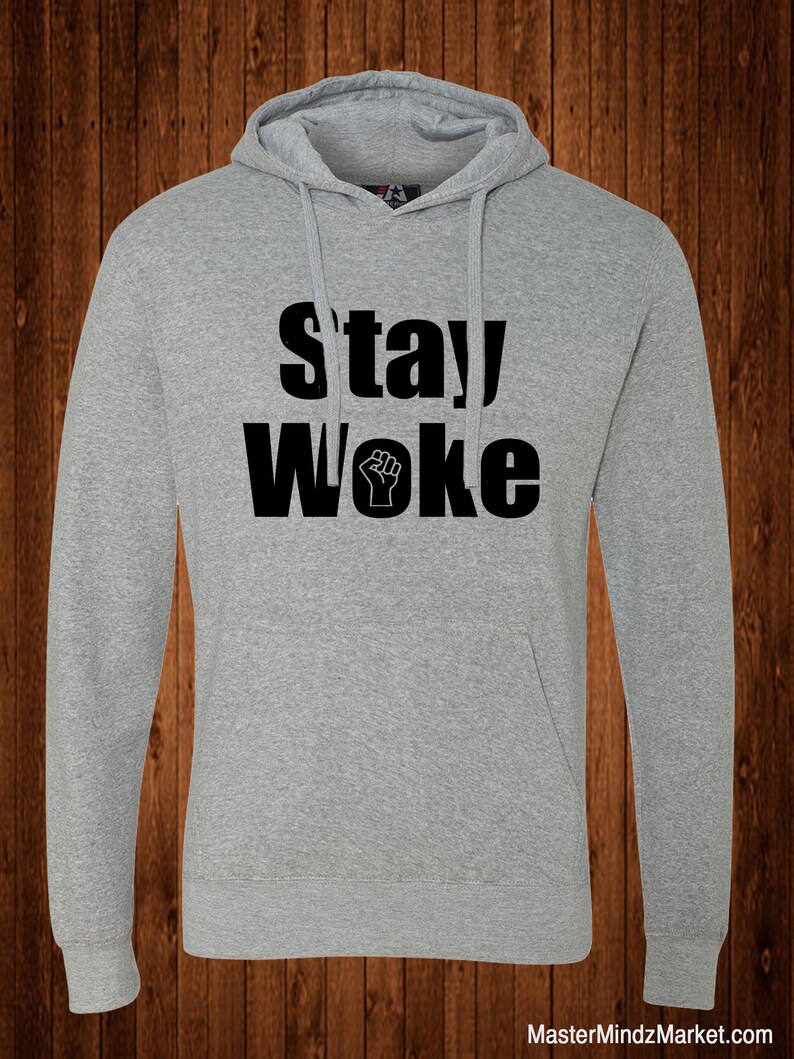 May include: A gray hooded sweatshirt with the text "stay woke" in black lettering and a raised fist symbol.