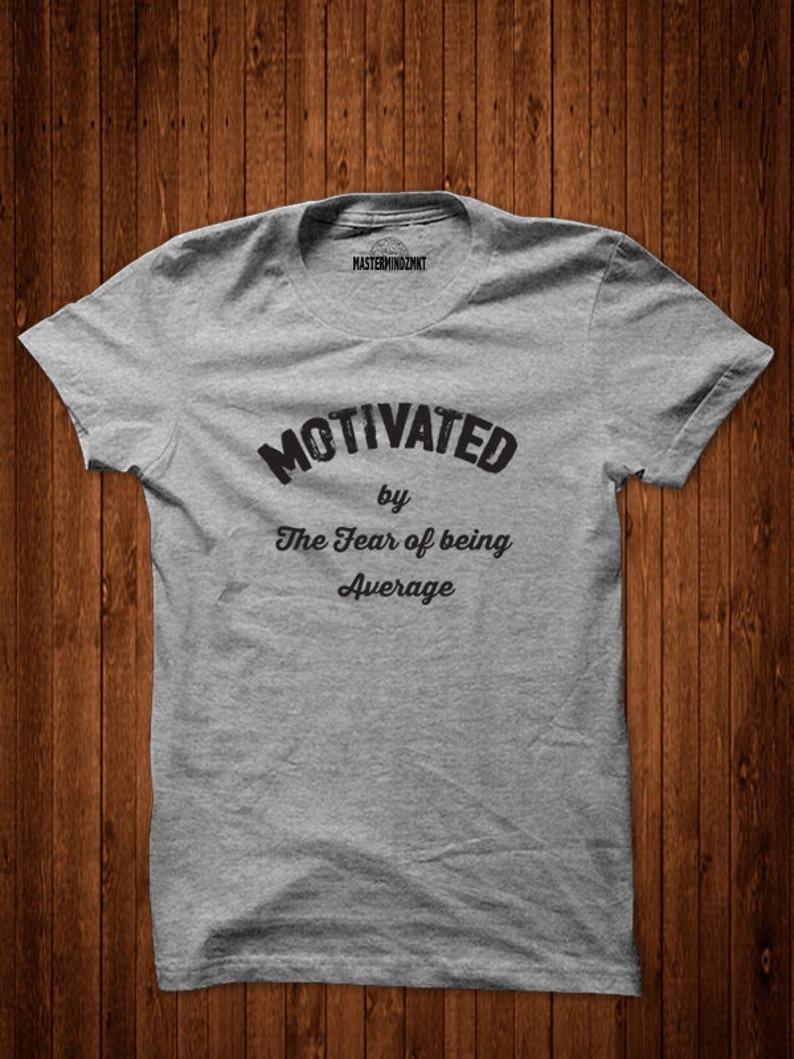 May include: Grey t-shirt with the text "Motivated by The Fear of being Average" printed on the front.