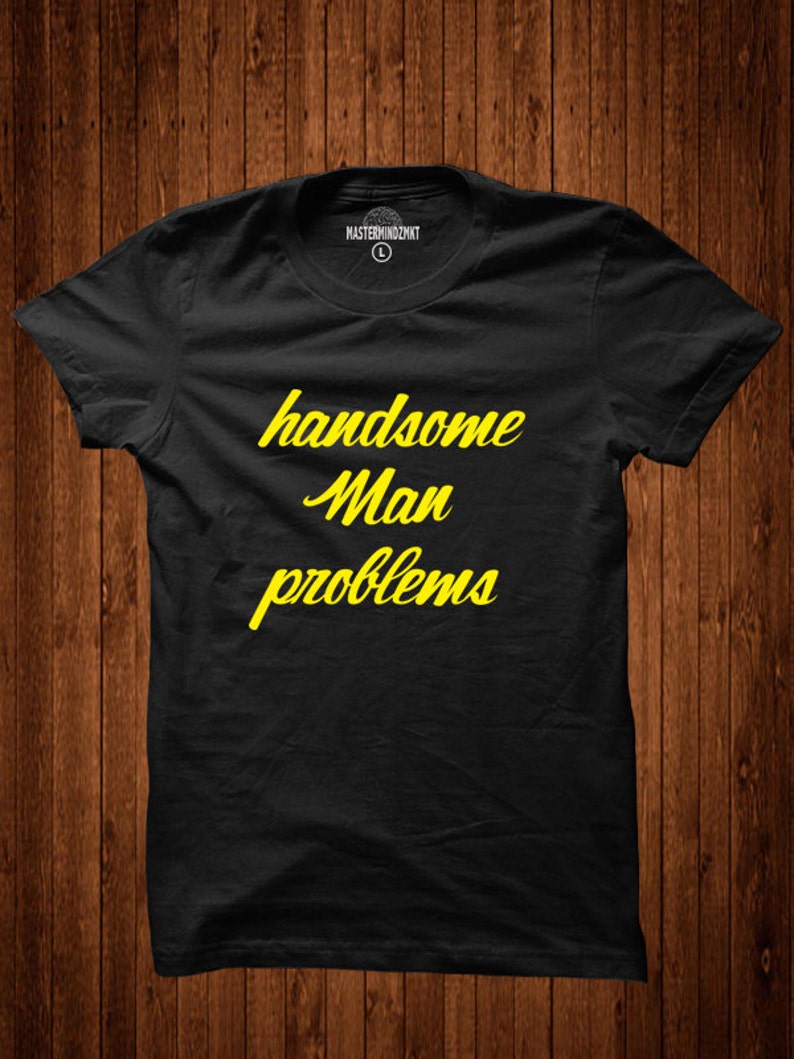 May include: Black t-shirt with yellow text that reads "handsome man problems".