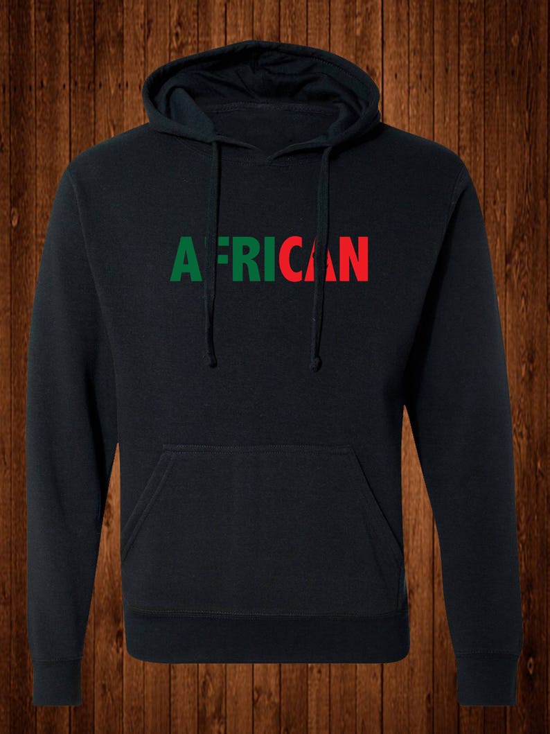 May include: Black hooded sweatshirt with the word "AFRICAN" printed across the chest. The word "AFRICAN" is in green and red block letters. The sweatshirt has a front pocket and a drawstring hood.