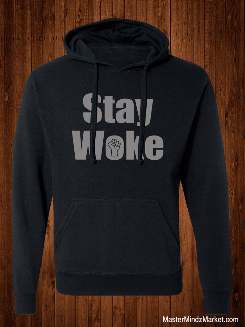 May include: A black hooded sweatshirt with the text "Stay Woke" in white letters and a raised fist symbol.