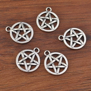 May include: Six silver-toned metal charms in the shape of a pentagram, each with a five-pointed star design. The charms have a loop at the top for attaching to jewelry or other crafts.