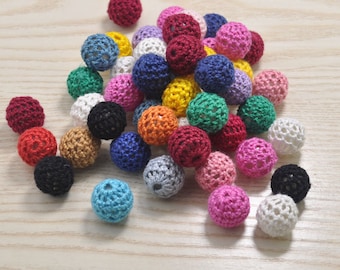 May include: A collection of colorful crocheted balls, featuring a variety of colors including red, blue, green, yellow, pink, and white. The balls are made of a soft, textured yarn and are perfect for crafting projects.