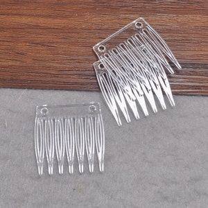 May include: Two clear plastic hair combs with a rectangular shape and seven teeth.