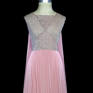 May include: A pink sleeveless gown with a silver beaded bodice and a flowing skirt.
