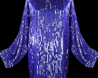May include: A long-sleeved, sequined dress in a vibrant purple hue. The dress has a loose, flowing fit and is adorned with silver sequins that create a shimmering effect.