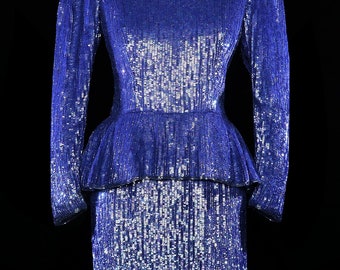 May include: A blue sequined dress with a fitted bodice and a full skirt. The dress has long sleeves and a round neckline.
