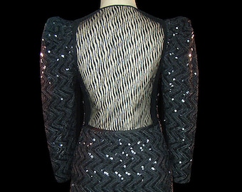 James Galanos sequin black dress with sheer back, zipper front, long sleeves, & sculptural shoulders, 1980s vintage couture power dress