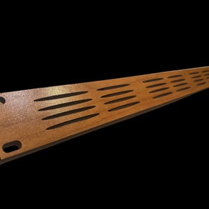 May include: A long, narrow, wooden slat with a series of evenly spaced, oval-shaped cutouts. The slat has a light brown wood grain and a slightly glossy finish.
