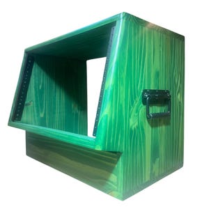 May include: A green wooden rack enclosure with a slanted front profile, featuring visible wood grain patterns throughout. The unit includes black metal rack rails with pre-drilled holes for mounting equipment and a black metal handle on the side.