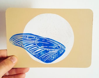 Linocut postcard blue butterfly wing on white moon