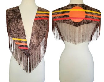 May include: A brown vest with a textured animal print pattern, featuring long fringe along the bottom edges. The garment is accented with horizontal yellow, orange, and red stripes, and a large orange circle on the back panel.