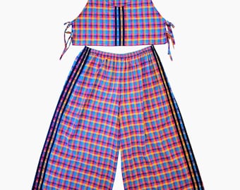 May include: A two-piece set consisting of a sleeveless crop top and wide-leg pants, both featuring a vibrant multi-colored plaid pattern in blue, pink, and orange. The top has side ties and three vertical black stripes, while the pants have black side stripes.