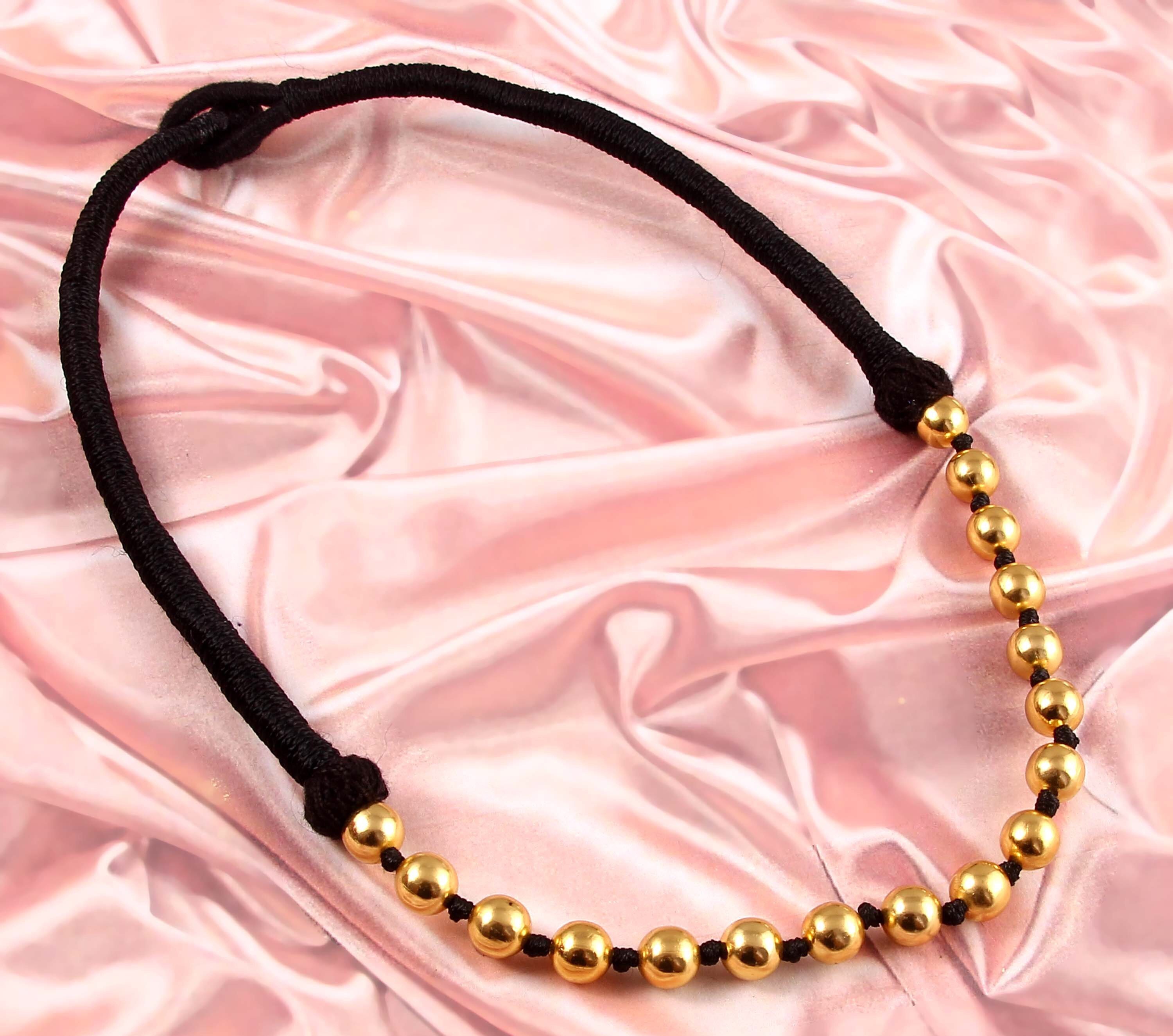 Gold pendant with store black thread
