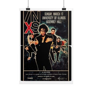May include: A concert poster for INXS featuring the band members in black clothing against a dark, textured background. The text reads INXS, Sunday, March 17, University of Illinois Assembly Hall, and includes ticket information at the bottom.