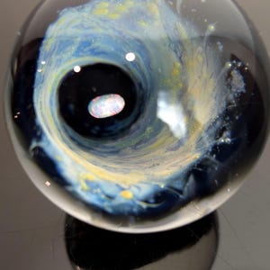 May include: A set of three ceramic mugs with a speckled, matte finish in cream, light grey, and dark grey. Each mug has a simple, minimalist design, suitable for coffee or tea.