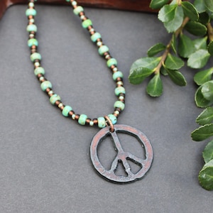 May include: A white ceramic mug with a black handle and the text "But First, Coffee" in a handwritten style. The mug is on a white surface. The mug is approximately 4 inches tall.