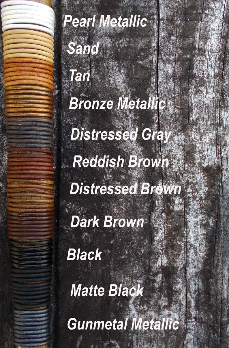 May include: A vertical stack of leather cord samples in various colours and finishes, including pearl metallic, sand, tan, bronze metallic, distressed grey, reddish brown, distressed brown, dark brown, black, matte black, and gunmetal metallic.