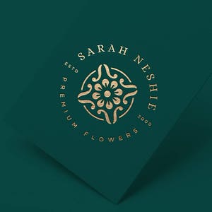 May include: Gold logo on a dark green background with the text "Sarah Neshie Premium Flowers Est. 2000" in a circle with a floral design in the center.
