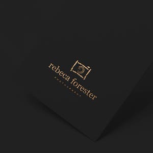 May include: A gold logo on a black background with the text "rebecca forester photography" and a stylized camera icon.