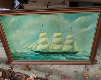 May include: A framed oil painting of a three-masted sailing ship on a turquoise sea under a cloudy sky. The ship has white sails and flags on the masts. The frame is a dark brown color.