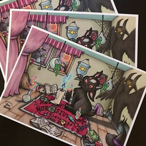 May include: A black cat with a pink bow sits on a red and purple Ouija board with a lit candle and crystals. The cat is looking at a stack of books with the words "Wings & Things" on the cover. A shadowy figure with horns and a pentagram is in the background.