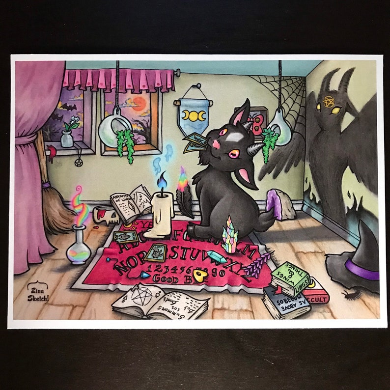 May include: A black cat with horns sits on a red and black Ouija board with a lit candle and a feather. The cat is looking at a card in its paw. The room is decorated with a broom, a skull, and other occult items. The text on the Ouija board reads "GOOD BYE" and "NOR STUV".