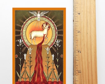 May include: A religious image depicting a white lamb standing on a golden altar with a red stream of blood flowing from its side. The lamb is surrounded by a halo with the words "PER SPIRITU: SANCTO SEMET IPSUM OBTULIT IMMACULATO DEO" in a circle. The image is set against a brown background with green plants and white flowers.