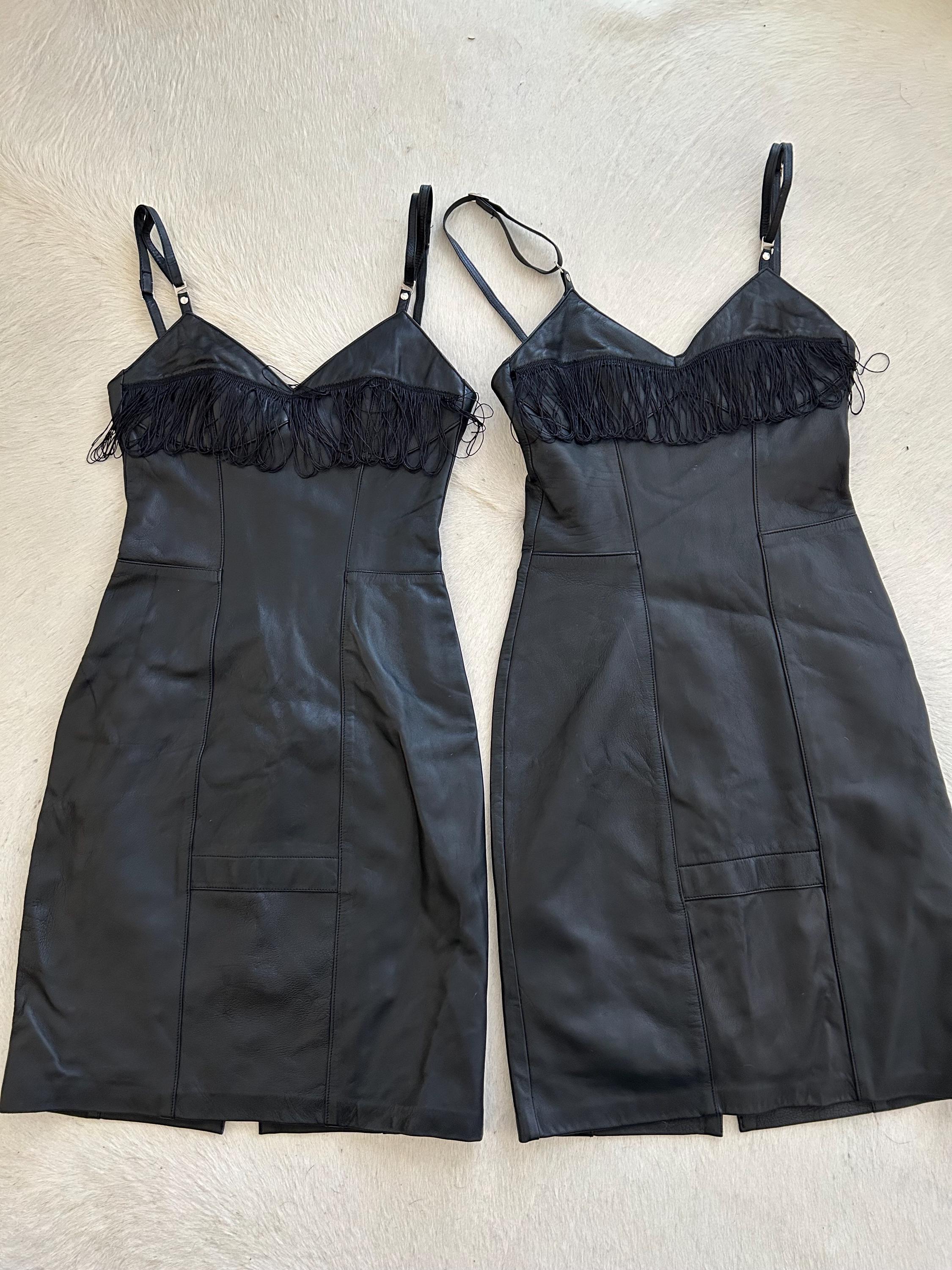 Black leather fully lined fringed dress with adjustable straps.