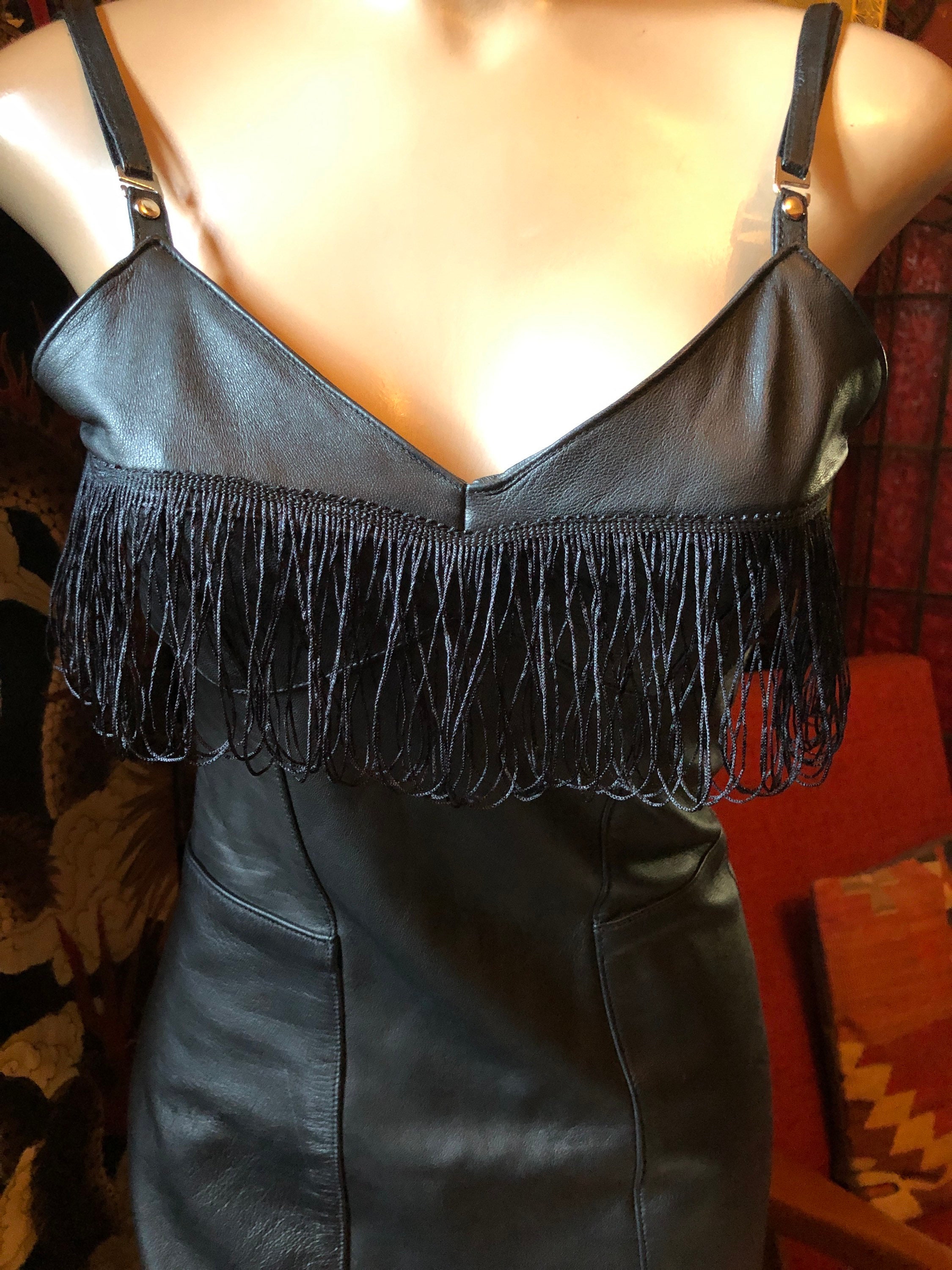 Black leather fully lined fringed dress with adjustable straps.