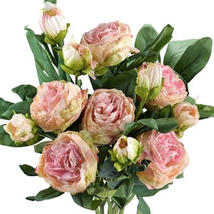 May include: A bouquet of blush pink artificial peonies with green leaves. The peonies are arranged in a cluster with some buds still closed.