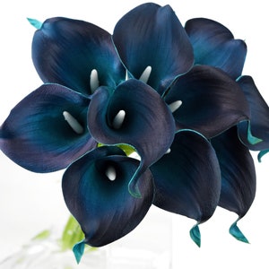 May include: A bouquet of teal blue artificial calla lilies. The flowers are arranged in a cluster and have a glossy finish.