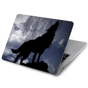 May include: A laptop computer with a black silhouette of a wolf howling at the moon. The background is a blue and white starry sky with a dreamcatcher design.
