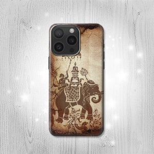 May include: A brown iPhone case with a vintage design featuring an elephant carrying a figure on its back. The design is reminiscent of traditional Thai art.