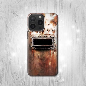 May include: A phone case with a rusty metal design. The case features a large, rectangular window with a black background and a metal frame. The case is made of a durable material and is designed to protect your phone from scratches and bumps.