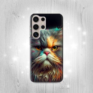 May include: A black phone case featuring a colorful, artistic rendering of a Persian cat's face. The cat has gray, orange, and white fur, with yellow eyes and a pink nose. The case has a camera cutout.
