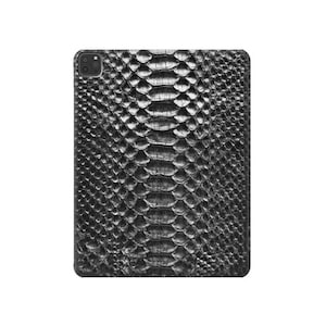 May include: Black leather phone case with a snakeskin pattern.