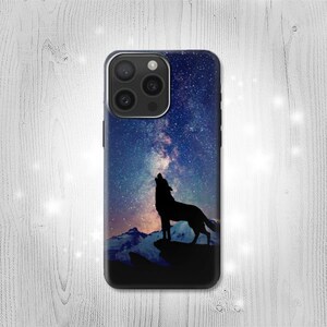 May include: A phone case featuring a silhouette of a howling wolf against a backdrop of a starry night sky. The design includes a mountain range at the bottom, with a color palette of blues, purples, and black.