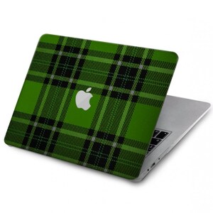 May include: Green and black plaid laptop skin with the Apple logo in the center.