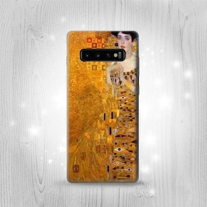 May include: A phone case with a gold background and a painting of a woman with a gold dress and a crown of flowers. The painting is a famous work of art by Gustav Klimt.